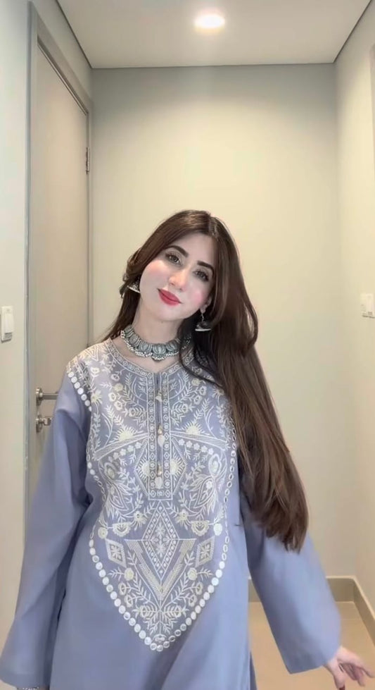 Stylish woman in embroidered grey kurta showcasing traditional design with modern elegance, perfect for festive wear